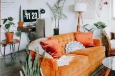 a lovely living space with an orange sofa