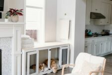 a built-in dog crate in white doubles as a console table is a cool idea and it perfectly matches the interior