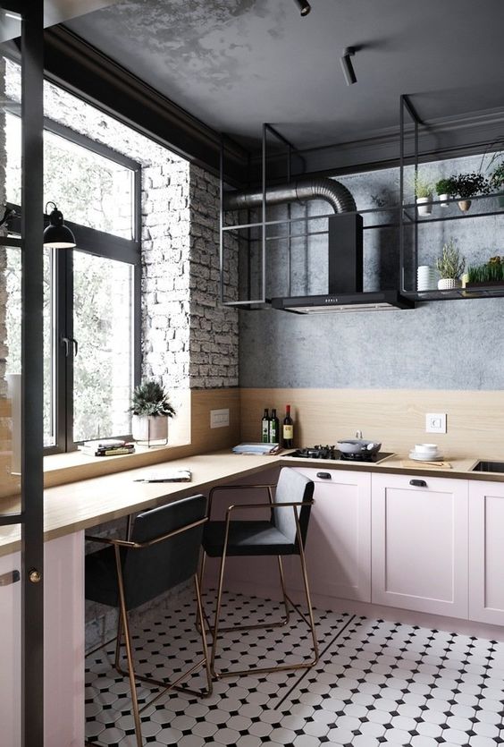 a catchy kitchen with low pink cabinets, a built-in dining space by the window, a black hood and black shelves
