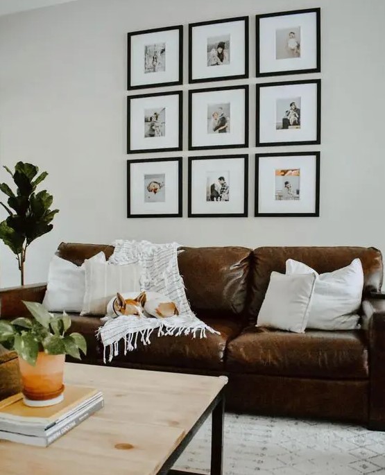 a cozy living room with a grid gallery wall