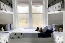 a cool kids’ room with multiple bunk beds, neutral and printed bedding, a grey rug is a stylish and cool space