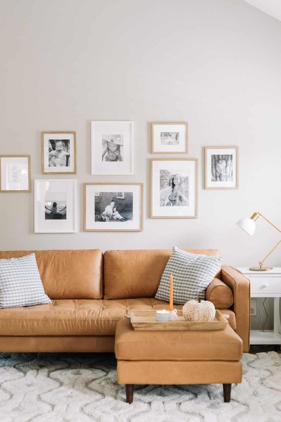 a lovely living room with a b&w gallery wall
