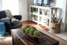 a dark-stained coffee table that is a chest provides you with some storage space, it adds a rustic feel