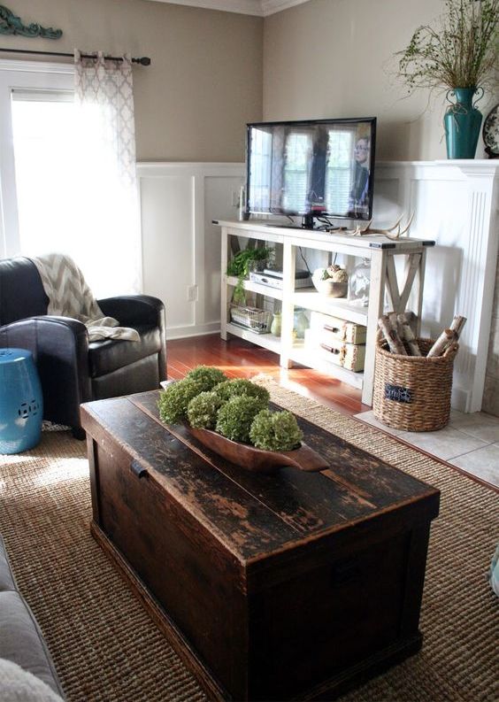 a dark stained coffee table that is a chest provides you with some storage space, it adds a rustic feel