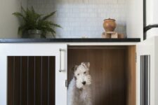 a dog crate built-in into a kitchen cabinet won’t prevent you from doing usual things while your pet is here