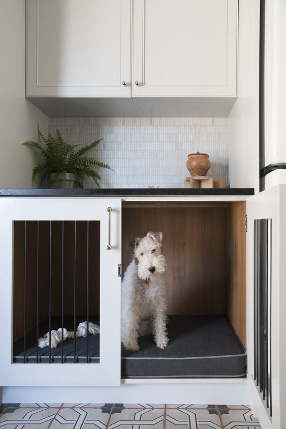 a dog crate built-in into a kitchen cabinet won't prevent you fromm doing usual things while your pet is here
