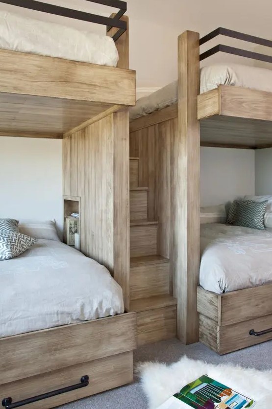 a farmhouse kids' room with built in stained bunk beds with neutral bedding and a built in ladder is a cozy space