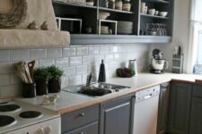 a graphite grey kitchen with open and flat panel cabinets, a white subway tile backsplash and white countertops