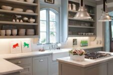 a grey farmhouse kitchen with shaker and open cabinets with no doors, a white tile backsplash and countertops looks elegant