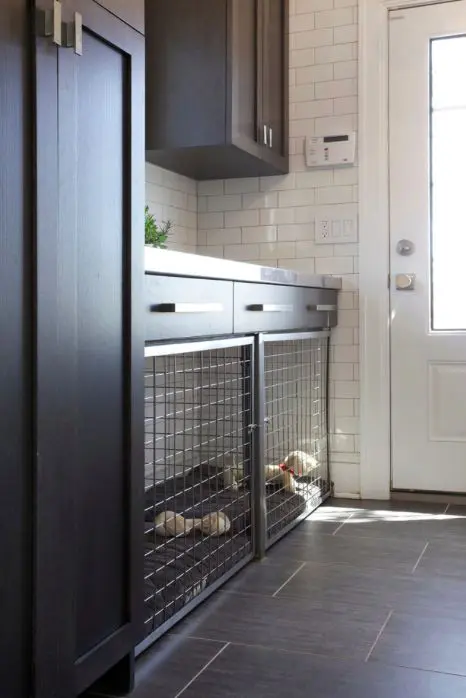 a large built-in dog kennel in a mudroom that doubles as a laundry is a cool idea for a modern space