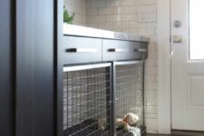 a large built-in dog kennel in a mudroom that doubles as a laundry is a cool idea for a modern space