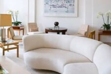 a long rounded creamy sectional sofa adds a whimsy touch to this contemporary space