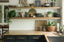 a mid-century modern kitchen with black shaker cabinets, beige granite countertops, white square tiles and open shelving