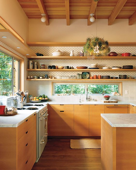 a mid-century modern kitchen with stained lower cabinets, white stone countertops, open shelving instead of upper cabinets and wallpaper backing