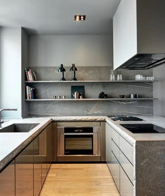 a minimalist grey kitchen with stone countertops and a backsplash plus open shelves instead of upper cabinets and built in appliances
