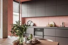 a cute minimalist kitchen with pink walls
