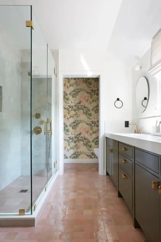 a bathroom with a wallpaper accent wall