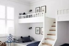 a modern farmhouse kids’ room with built-in bunk beds, navy and white bedding, layered rugs and side tables and baskets