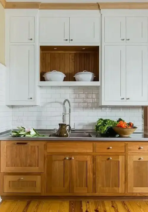 a modern farmouse kitchen with lower stained cabinets, upper white ones, a white subway tile backsplash, a metal countertop for a cozy look and maximal functionality