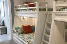 a modern kids’ room with built-in bunk beds, bright printed bedding, built-in lights is a cool and welcoming space for children