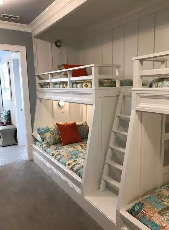 a modern kids' room with built in bunk beds, bright printed bedding, built in lights is a cool and welcoming space for children