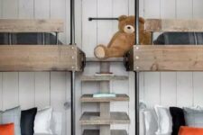 a modern rustic kids’ room with a white shiplap wall, stained bunk beds with a wooden ladder and moody bedding is a stylish solution
