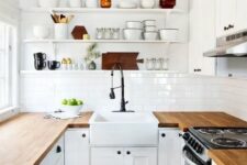 a modern white farmhouse kitchen with light stained butcherblock countertops that add warmth and interest to the space