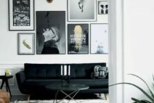 a monochromatic black and white living room with a catchy black sofa, a black and white gallery wall, a side and a coffee table and a brown leather pouf