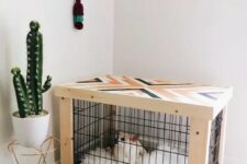 a pretty mid-century modern dog kennel with a geometric pattern on top and a geo printed mattress