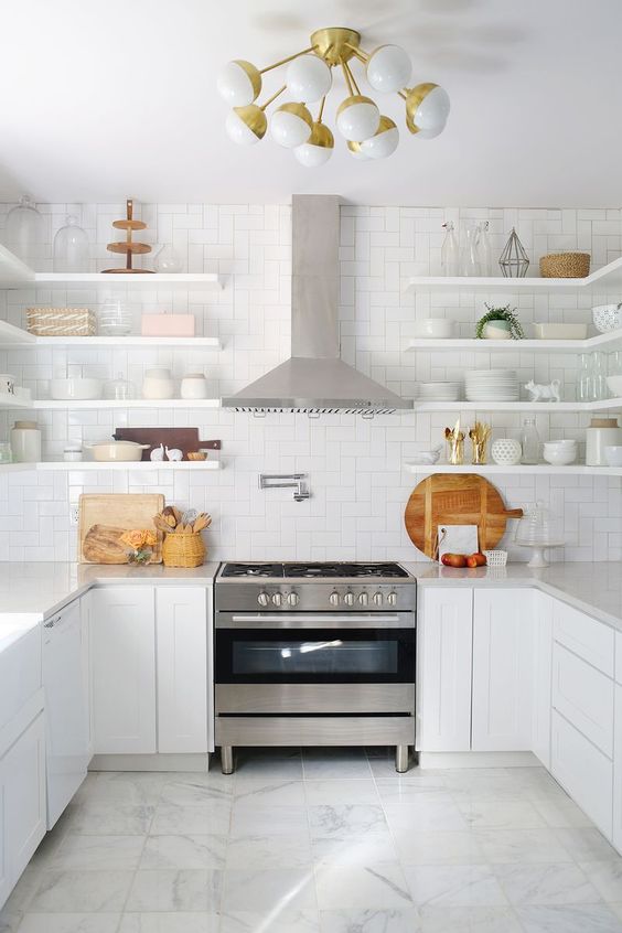 a pure white kitchen with shaker lower cabinets, open shelving instead of upper ones, stainless steel appliances