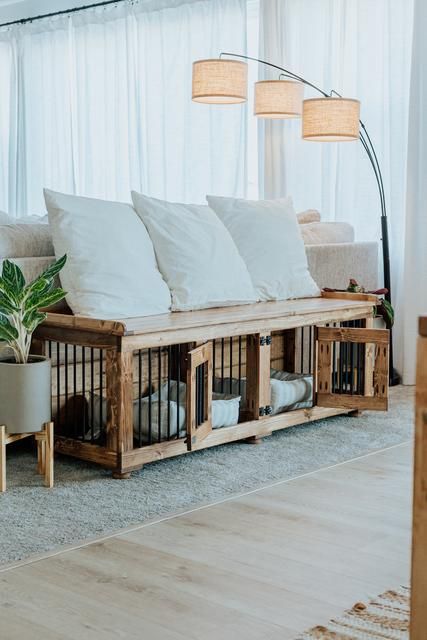 a shared dog kennel of stained wood and metal doubles as a sitting bench and looks very cozy and cute