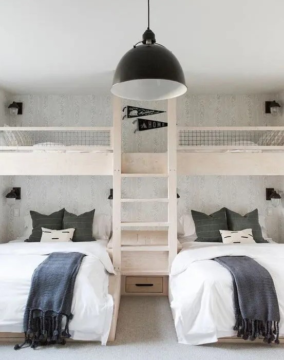 a simple and contrasting kids' room with built-in bunk beds with white and graphite grey bedding, a ladder and a black pendant lamp