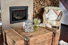 a stained vintage chest as a coffee table in the rustic space, it looks very rustic and farmhouse-like