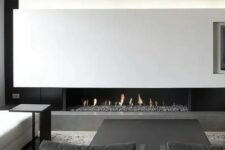 a stylish b&w living room with a built-in fireplace