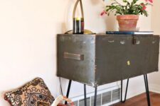 a vintage trunk placed on hairpin legs is a creative alternative to a console table