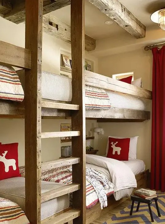 a welcoming kids' room with stained built in bunk beds, with a ladder and bright and neutral bedding, a rug and curtains