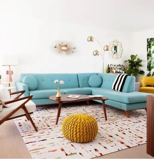 a welcoming mid-century modern living room with a modern turquoise sofa, elegant mid-century modern furniture and touches of gold for chic