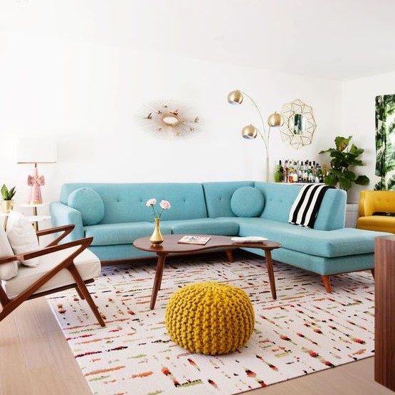 a welcoming mid century modern living room with a turquoise sofa, elegant mid century modern furniture and touches of gold for chic