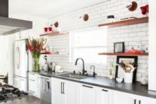 a white farmhouse kitchen with concrete countertops, black handles, rich-stained open shelves and appliances is very cool