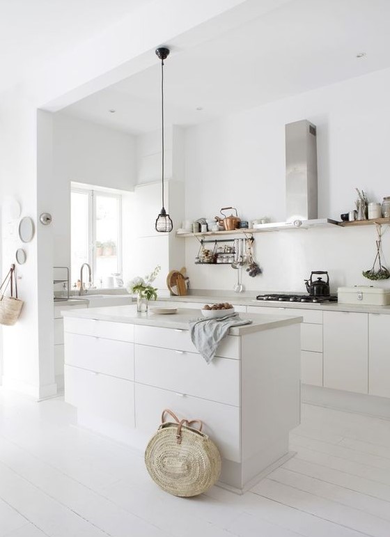 a white minimalist kitchen with sleek cabinets, concrete countertops,open shelves instead of upper cabinets,  stainless steel appliances
