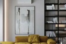 a yellow L-shaped sectional sofa adds color to this monochrome space and makes it shine