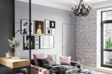 an eclectic living room with a brick wall, a gray sofa with pink pillows and a pink chair, a round ottoman and a gallery wall
