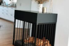 an elegant black console table with a built-in dog crate and a pillow inside is a minimalist and stylish solution for an wakward nook