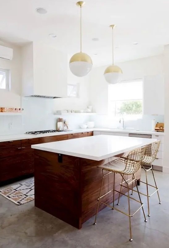 dark stained wood and white cabinets, open white shelves and a white hood, a large kitchen island with gold stools and pendant lamps