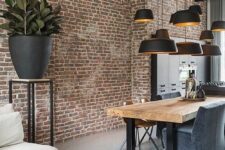 06 a stylish modern industrial space with a living edge table, grey chairs, a cluster of black pendant lamps and a potted plant