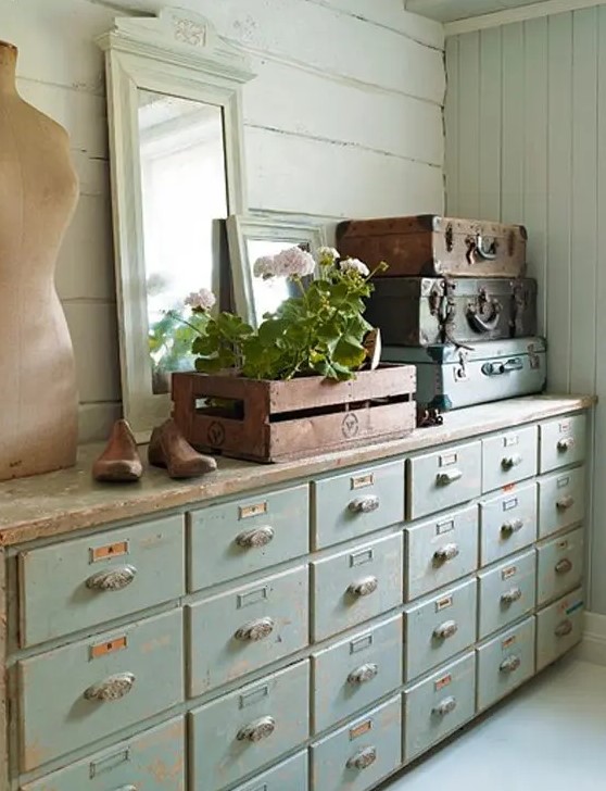 a shabby chic mint colored apothecary cabinet will provide a lot of storag espace for a soft pastel interior in rustic and vintage style