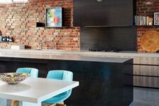 10 an eclectic kitchen with sleek light and dark cabinets, a red brick wall and bright turquoise chairs
