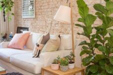 17 a cozy living room with a muted brick wall that is textural yet rather soft-looking