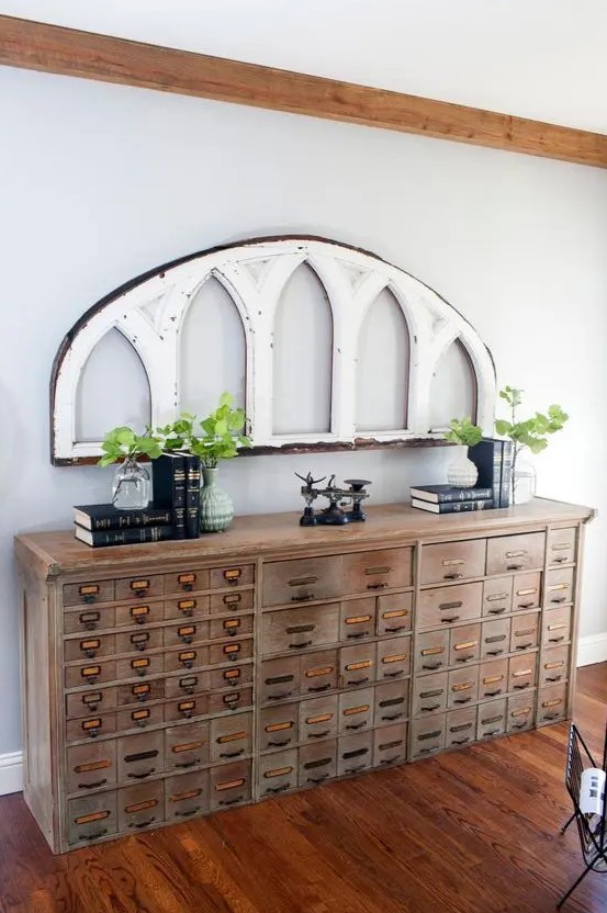 a vintage wooden apothecary cabinet as a gorgeous console table that will bring a rustic and vintage feel to the space