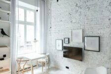 21 a monochromatic living room with a white brick wall and a rough ceiling for a touch of drama